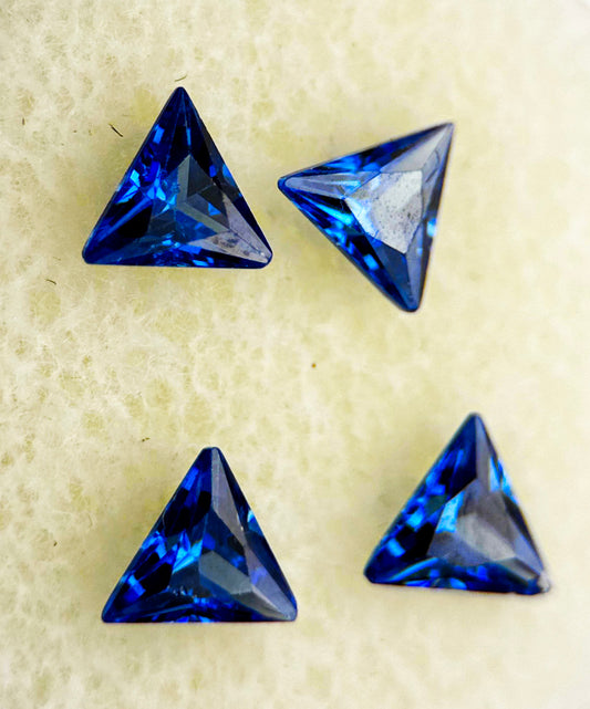 Four blue triangle sapphires, total 1.93 carats, IF clarity, standard heated